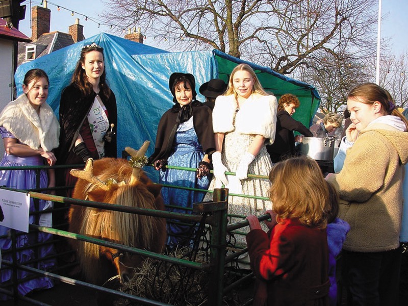 Olney Ladies including Elaine Baron, pictured on Dickens Day with a Reindeer